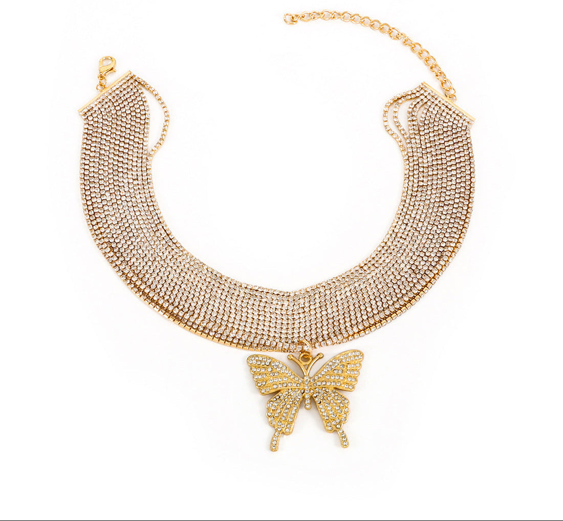 Gold necklace with a butterfly pendant on a white background