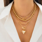 Gold necklaces with a heart pendant on a white background