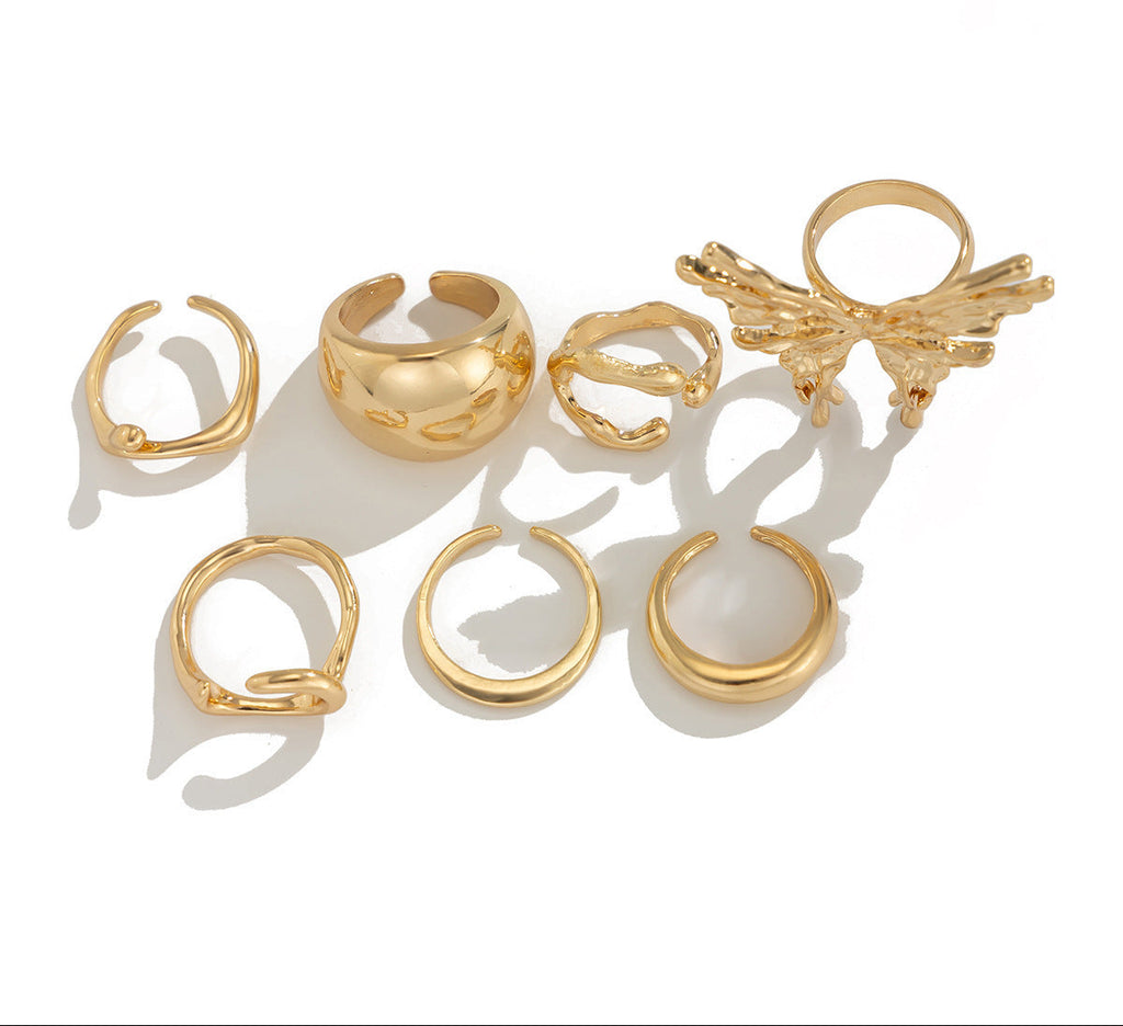 Set of gold rings with different designs on a white background