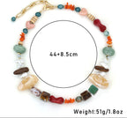 Multicolored beaded necklace with gold clasp on a white background